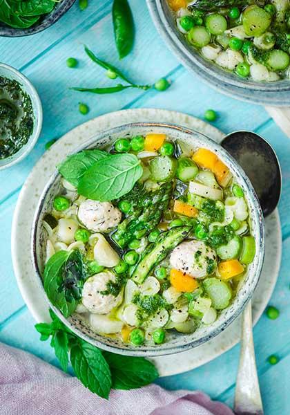 Soupe de printemps aux petits pois, asperges, boulettes de volaille, pâtes et pesto de menthe